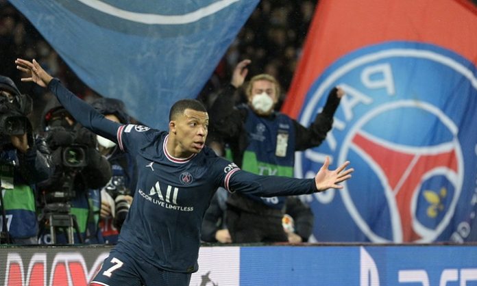 Kylian Mbappe with PSG flag